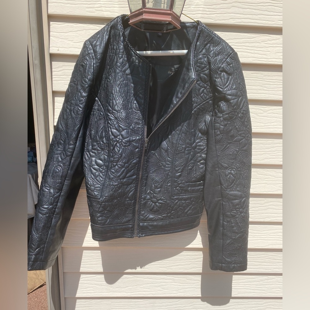 Unique Sisters brand imprinted faux leather zip-up jacket. Size L